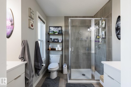 Full bathroom featuring vanity, a stall shower, and tile patterned floors - 1710 Keene Crescent. Sw, Edmonton, AB - Indoor Photo Showing Bathroom