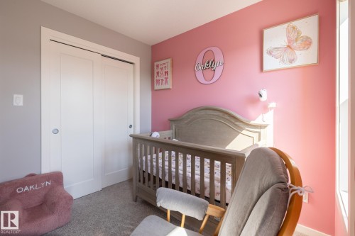 Bedroom with a crib, a closet, and carpet floors - 1710 Keene Crescent. Sw, Edmonton, AB - Indoor Photo Showing Bedroom