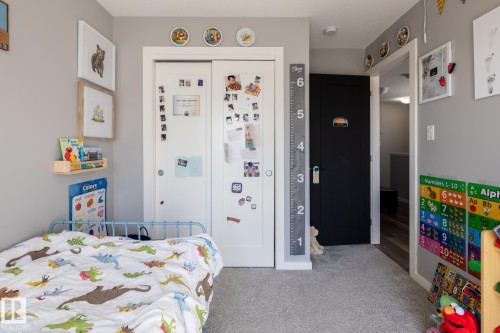 Bedroom with light carpet and a closet - 1710 Keene Crescent. Sw, Edmonton, AB - Indoor Photo Showing Bedroom