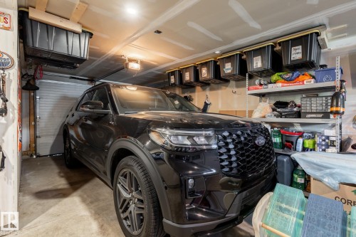 Garage featuring a garage door opener - 1710 Keene Crescent. Sw, Edmonton, AB - Indoor Photo Showing Garage