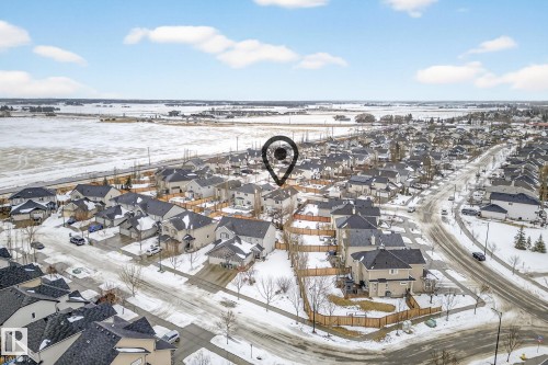 Snowy aerial view featuring a residential view - 152 Rue Marquet, Beaumont, AB - Outdoor With View