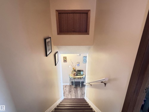 Stairs featuring wood finished floors and baseboards - 10503 110 Street, Westlock, AB 
