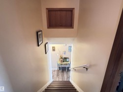Stairs featuring wood finished floors and baseboards - 