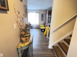Hallway featuring a textured ceiling and dark wood finished floors - 