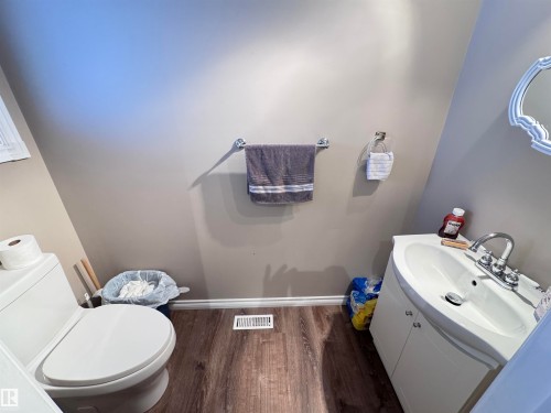 Bathroom featuring vanity and dark wood finished floors - 10503 110 Street, Westlock, AB 