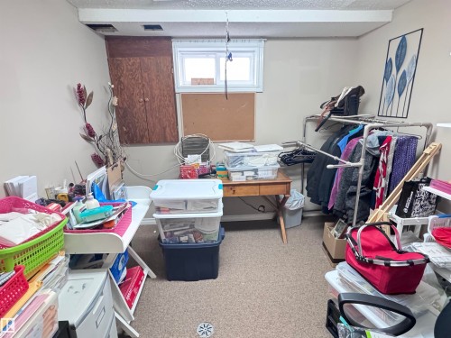 Miscellaneous room with a textured ceiling and carpet - 10503 110 Street, Westlock, AB 