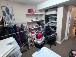 Office space with dark carpet and a textured ceiling - 
