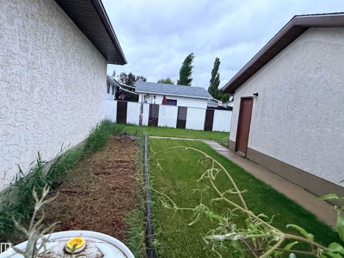 Exterior stucco finish and dark trim details - 10503 110 Street, Westlock, AB 