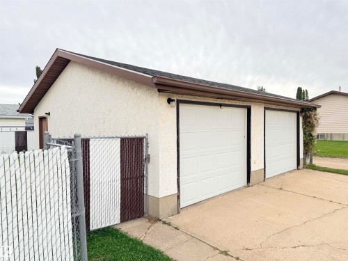 Two-car garage with white panel doors and stucco exterior - 10503 110 Street, Westlock, AB 