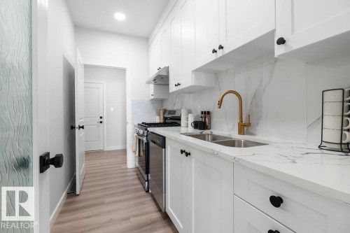 Kitchen with white cabinetry, light stone countertops, stainless steel appliances, light wood-style floors, and recessed lighting - 3722 41 Avenue, Beaumont, AB - Indoor Photo Showing Kitchen With Double Sink With Upgraded Kitchen