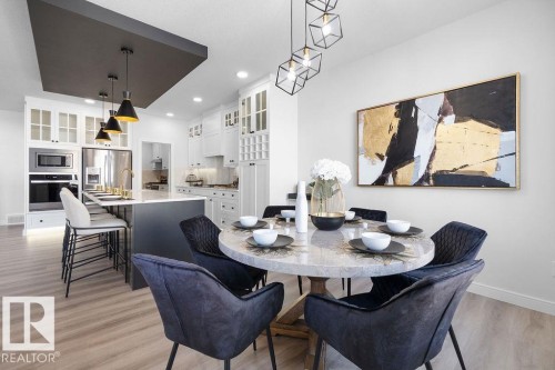 Dining room featuring light wood-type flooring and recessed lighting - 3722 41 Avenue, Beaumont, AB - Indoor Photo Showing Dining Room