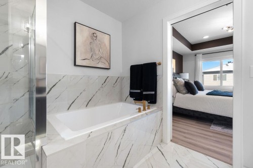 Ensuite bathroom featuring a garden tub, light marble finish flooring, and a marble finish shower - 3722 41 Avenue, Beaumont, AB - Indoor Photo Showing Bathroom