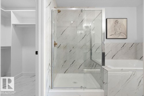 Full bathroom with light marble finish floors, a marble finish shower, and a garden tub - 3722 41 Avenue, Beaumont, AB - Indoor