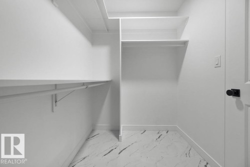 Walk in closet with light marble finish flooring - 3722 41 Avenue, Beaumont, AB - Indoor With Storage