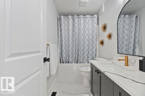 Full bathroom with vanity, shower / bath combo, and light marble finish floors - 3722 41 Avenue, Beaumont, AB - Indoor Photo Showing Bathroom