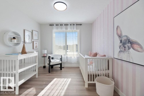 Bedroom with a nursery area and light wood finished floors - 3722 41 Avenue, Beaumont, AB - Indoor