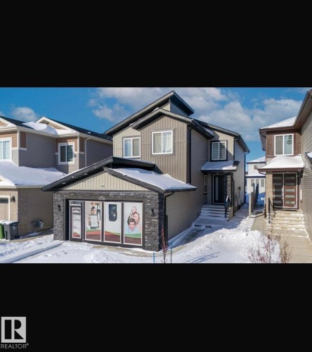 View of front of house featuring board and batten siding and stone siding - 3722 41 Avenue, Beaumont, AB - Outdoor With Facade