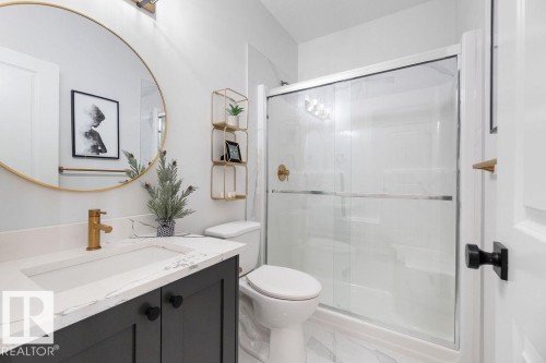 Full bath with vanity, a stall shower, and light marble finish flooring - 3722 41 Avenue, Beaumont, AB - Indoor Photo Showing Bathroom