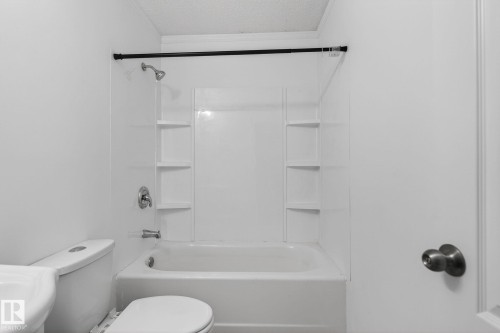 Bathroom with crown molding, shower / tub combination, and a textured ceiling - 72 Evergreen Park, Edmonton, AB - Indoor Photo Showing Bathroom
