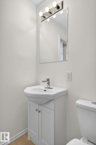 Half bathroom with vanity, light wood finished floors, and a textured ceiling - 72 Evergreen Park, Edmonton, AB - Indoor Photo Showing Bathroom