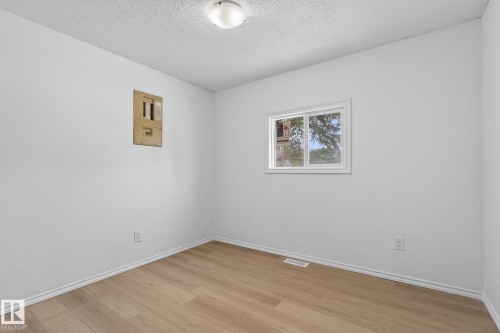 Empty room featuring a textured ceiling and light wood-style floors - 72 Evergreen Park, Edmonton, AB - Indoor Photo Showing Other Room