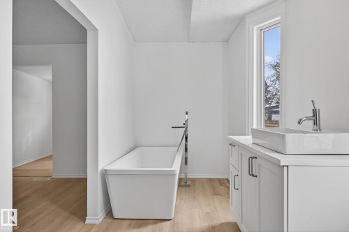 Laundry area featuring light wood finished floors and ornamental molding - 72 Evergreen Park, Edmonton, AB - Indoor Photo Showing Laundry Room