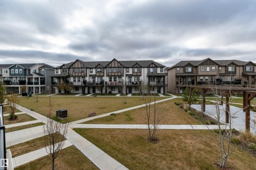 View of community with a residential view and a yard - 105 2072 Wonnacott Way, Edmonton, AB - Outdoor With Facade