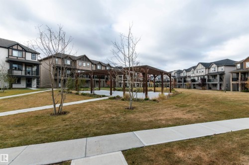 Surrounding community with a residential view and a lawn - 105 2072 Wonnacott Way, Edmonton, AB - Outdoor With Facade