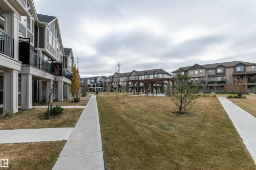 Surrounding community with a residential view and a yard - 105 2072 Wonnacott Way, Edmonton, AB - Outdoor With Facade