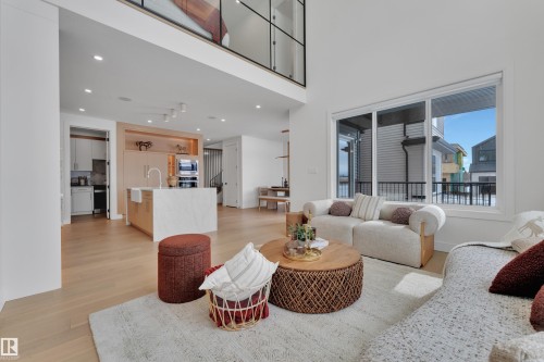 Living room featuring light wood-style flooring, recessed lighting, and a high ceiling - 2408 1 Ave Sw, Edmonton, AB - Indoor Photo Showing Living Room