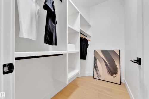 Walk in closet featuring light wood-style flooring - 2408 1 Ave Sw, Edmonton, AB - Indoor