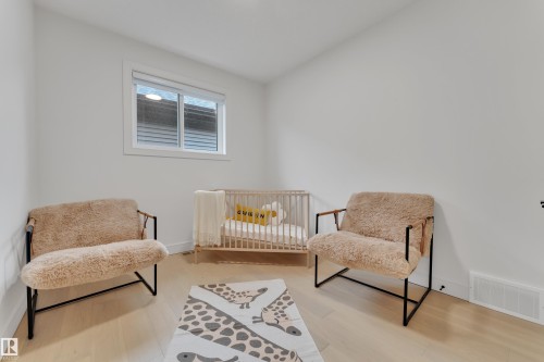 Bedroom with light wood-style floors - 2408 1 Ave Sw, Edmonton, AB - Indoor