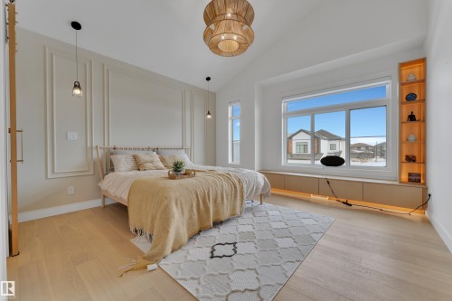 Bedroom featuring light wood-type flooring and lofted ceiling - 2408 1 Ave Sw, Edmonton, AB - Indoor Photo Showing Bedroom