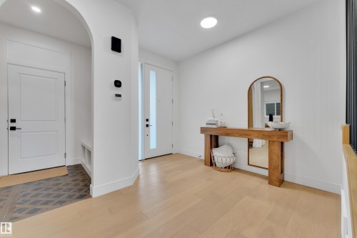 Entrance foyer featuring arched walkways, light wood-style flooring, and recessed lighting - 2408 1 Ave Sw, Edmonton, AB - Indoor Photo Showing Other Room