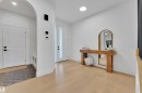 Entrance foyer featuring arched walkways, light wood-style flooring, and recessed lighting - 2408 1 Ave Sw, Edmonton, AB  - Indoor Photo Showing Other Room 