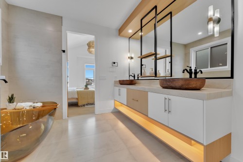 Ensuite bathroom featuring double vanity, a freestanding tub, and recessed lighting - 2408 1 Ave Sw, Edmonton, AB - Indoor Photo Showing Bathroom