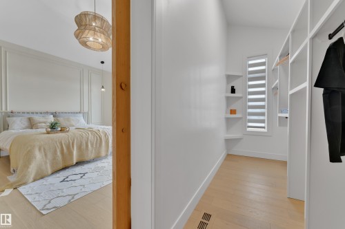 Corridor featuring light wood-style floors and baseboards - 2408 1 Ave Sw, Edmonton, AB - Indoor Photo Showing Other Room