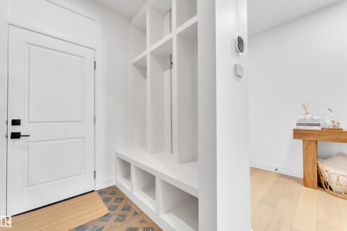 Mudroom featuring light wood-style floors and baseboards - 2408 1 Ave Sw, Edmonton, AB - Indoor