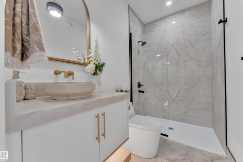 Full bath with vanity, a marble finish shower, light marble finish flooring, and recessed lighting - 2408 1 Ave Sw, Edmonton, AB - Indoor Photo Showing Bathroom