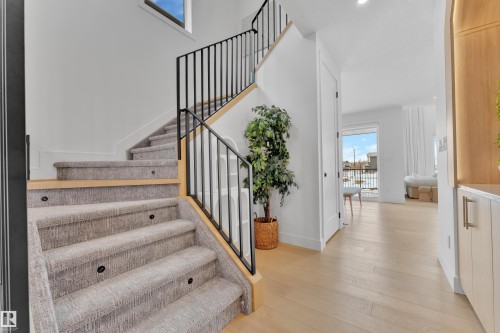 Stairs featuring hardwood / wood-style floors and baseboards - 2408 1 Ave Sw, Edmonton, AB - Indoor Photo Showing Other Room