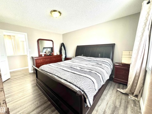 Bedroom featuring wood finished floors and a textured ceiling - 6734 162A Avenue, Edmonton, AB - Indoor Photo Showing Bedroom