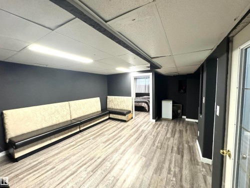 Interior space featuring a drop ceiling and light wood-type flooring - 6734 162A Avenue, Edmonton, AB - Indoor