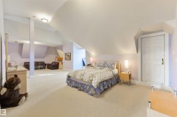 Bedroom with carpet flooring and lofted ceiling - 
