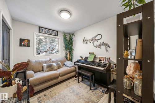 Living area featuring a textured ceiling and light wood-style floors - 103 Adams Close, Red Deer, AB - Indoor Photo Showing Living Room