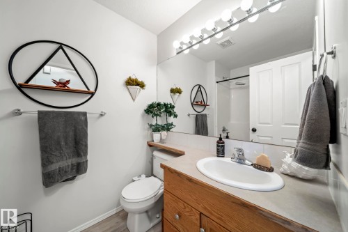 Full bath featuring vanity, a shower, and light wood-type flooring - 103 Adams Close, Red Deer, AB - Indoor Photo Showing Bathroom