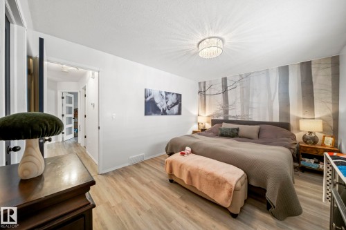 Bedroom featuring light wood-type flooring and a textured ceiling - 103 Adams Close, Red Deer, AB - Indoor Photo Showing Bedroom