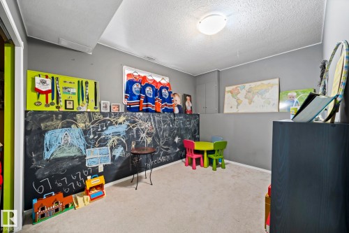 Rec room featuring a textured ceiling and carpet floors - 103 Adams Close, Red Deer, AB - Indoor Photo Showing Other Room