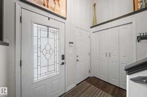 Entrance foyer with dark wood-type flooring - 103 Adams Close, Red Deer, AB - Indoor Photo Showing Other Room
