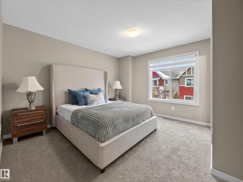 Bedroom with carpet and a textured ceiling - 125 655 Tamarack Road, Edmonton, AB - Indoor Photo Showing Bedroom
