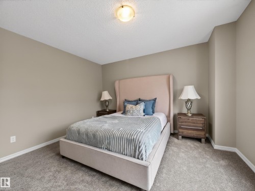 Bedroom with carpet floors and a textured ceiling - 125 655 Tamarack Road, Edmonton, AB - Indoor Photo Showing Bedroom